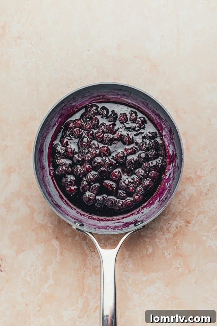 The cooked blueberry compote in a saucepan.