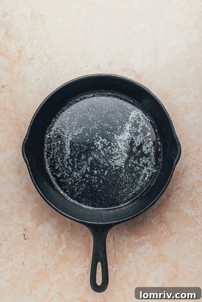A hot skillet with melted butter.