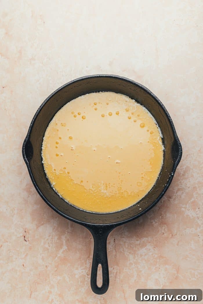 A hot skillet with Dutch baby pancake batter.