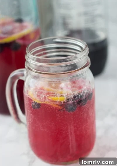 Refreshing Sparkling Blueberry Lemonade with fresh berries and mint