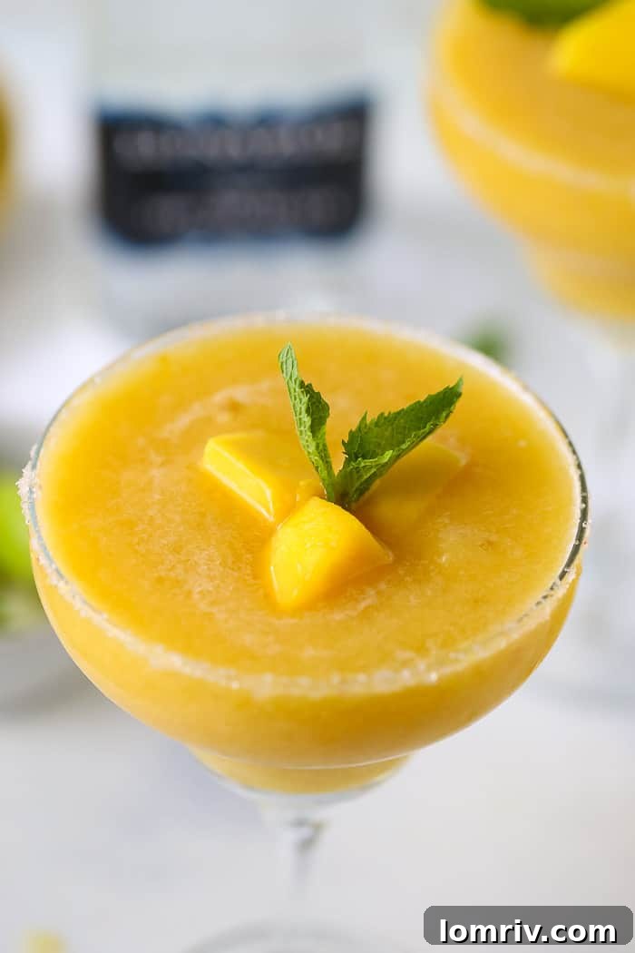 Three Frozen Mango Margaritas on a tray, ready to serve