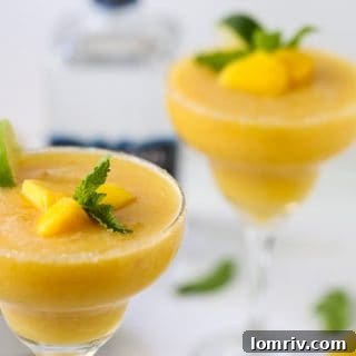 Tropical Frozen Mango Margaritas with fresh lime and frosty glasses
