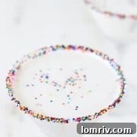 Birthday Cake Martini, a sweet and festive cocktail with a sprinkle-rimmed glass.