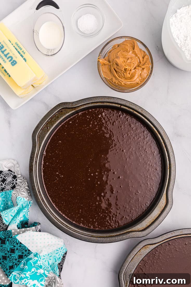 Chocolate cake batter divided into pans.