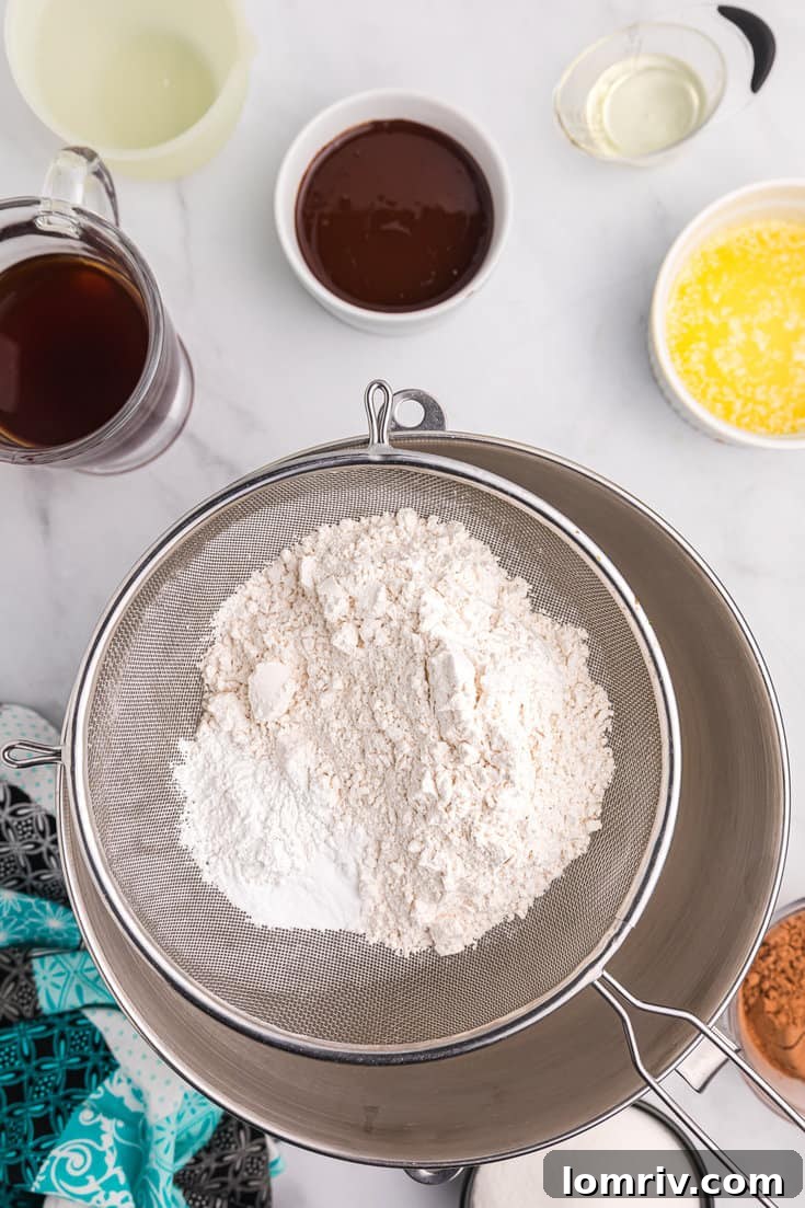 Flour being sifted for chocolate cake.