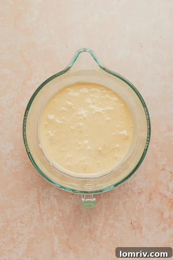 The mixing bowl with the fully prepared, airy cake batter, ready for baking.