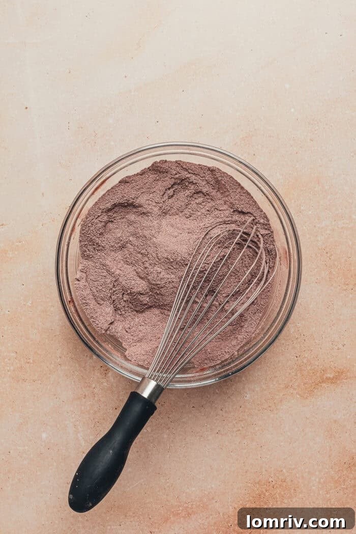 Dry ingredients for the chocolate cupcakes in a glass bowl.