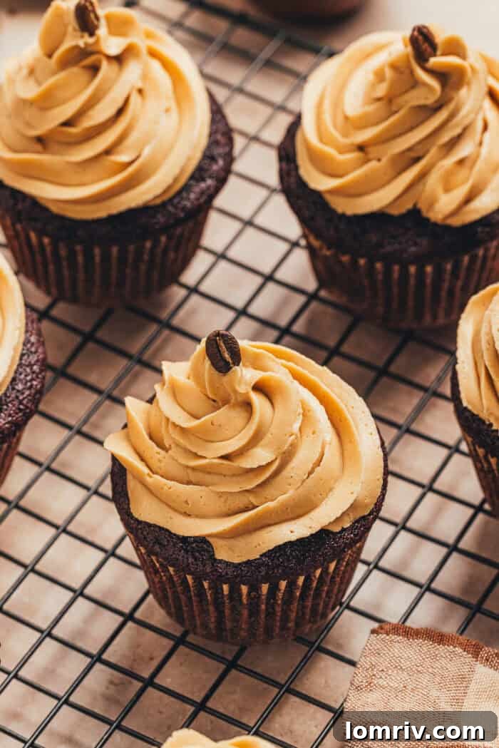 Freshly baked chocolate espresso cupcakes cooling on a wire rack.