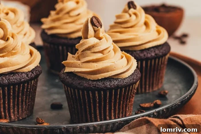 A close-up of two perfect chocolate espresso cupcakes on a platter, ready to be served.