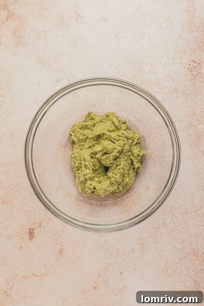 A glass bowl with pistachio and mascapone mixed together.