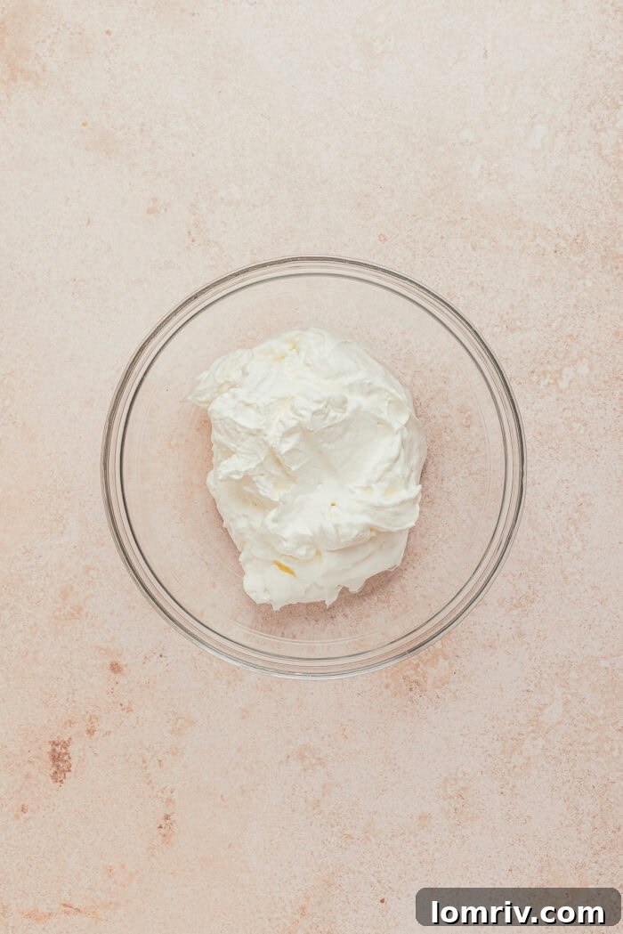 A glass bowl filled with heavy cream.