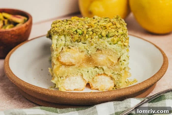A slice of lemon pistachio tiramisu on a plate.
