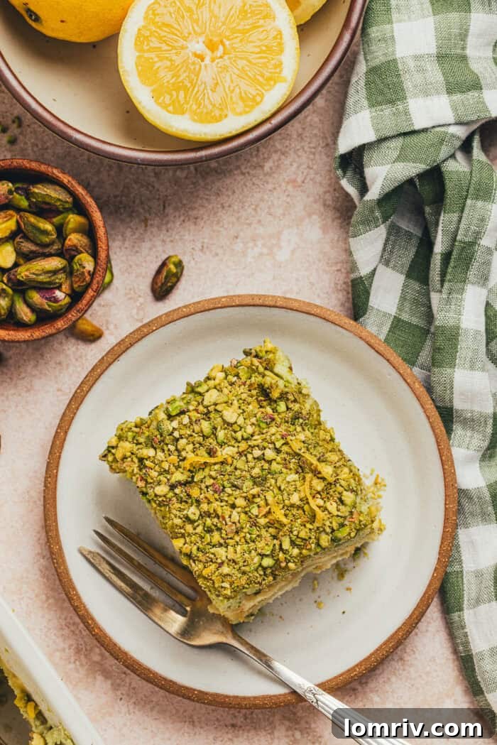 A slice of lemon pistachio tiramisu on a plate.